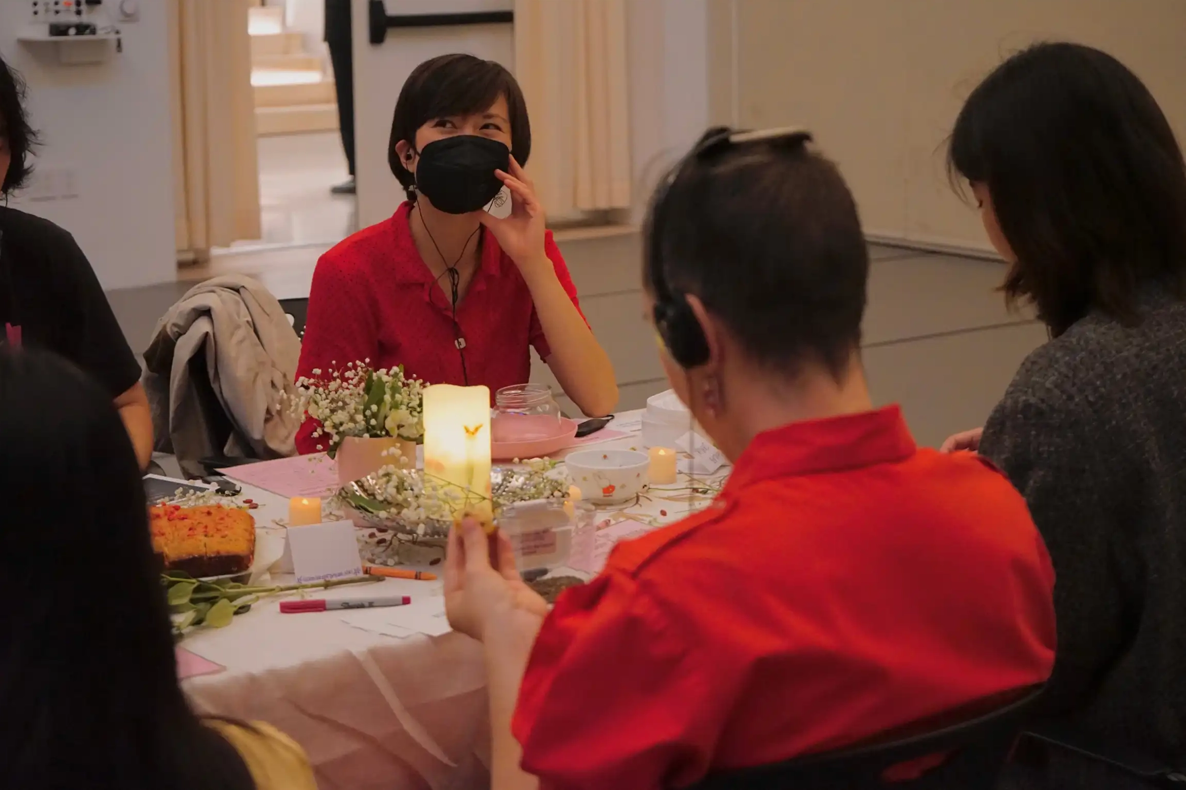 Various attendees wearing headphones, listening to recordings around the dining table